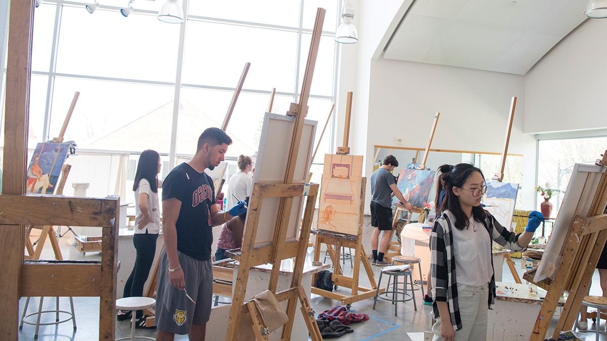 Students painting in an art class