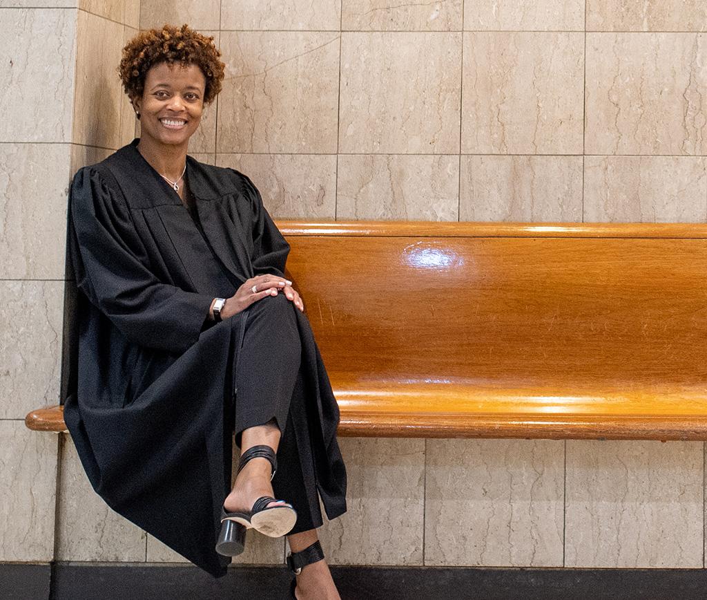 Judge Shartrese Flowers seated on a wooden bench