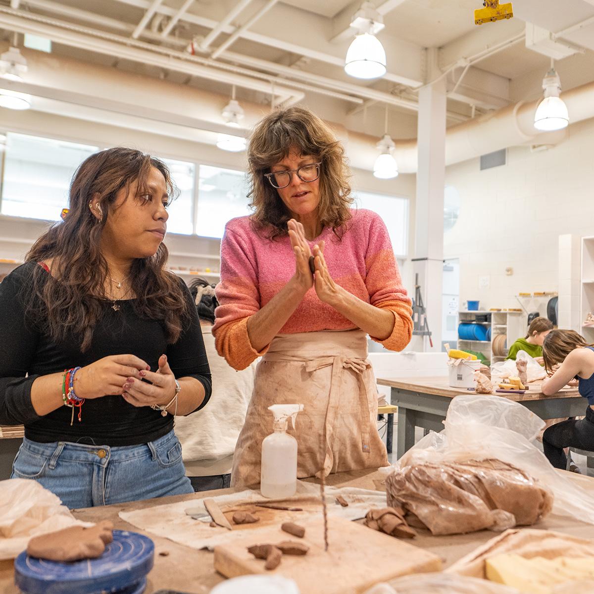 Professor Meredith Brickell with students in Peeler's pottery room